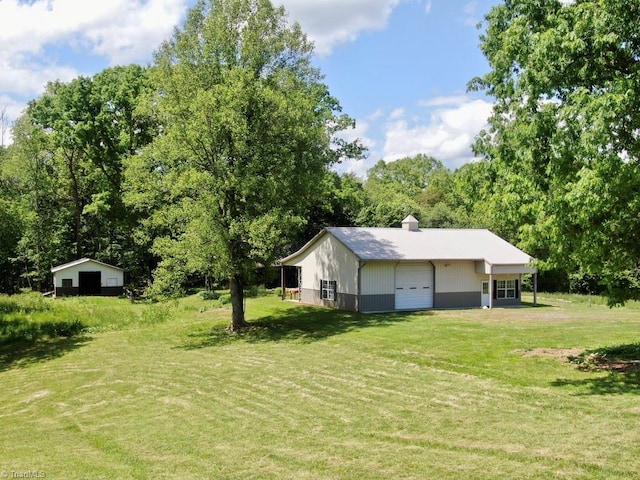 431 Needham Rd, Pilot Mountain, NC 27041 - view of grassy yard with a garage and an outbuilding