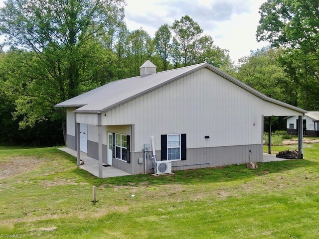 431 Needham Rd, Pilot Mountain, NC 27041 - back of house with a cooling unit, a lawn, a garage, and metal roof