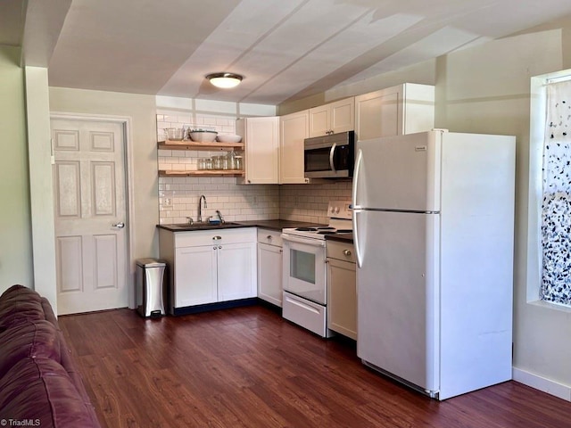 431 Needham Rd, Pilot Mountain, NC 27041 - kitchen with white appliances, dark countertops, a sink, backsplash, and dark wood-type flooring