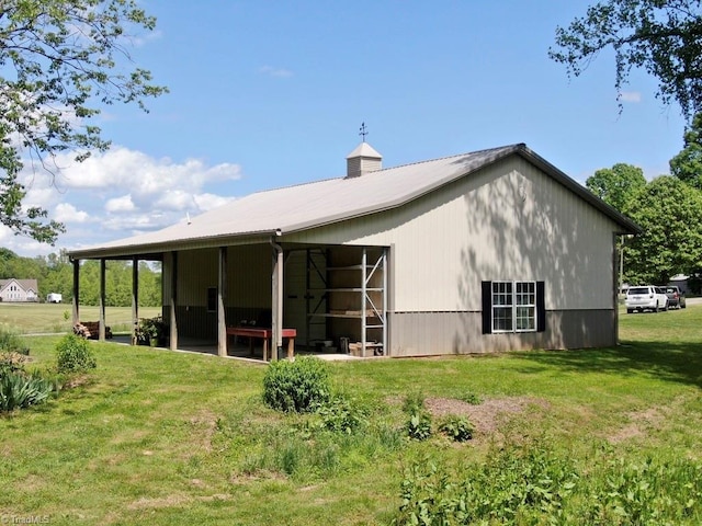 431 Needham Rd, Pilot Mountain, NC 27041 - rear view of property with a pole building, an outbuilding, a lawn, and metal roof