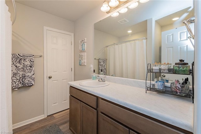 1765 Midway School Rd, Winston-Salem, NC 27107 - bathroom with vanity, baseboards, visible vents, and wood finished floors