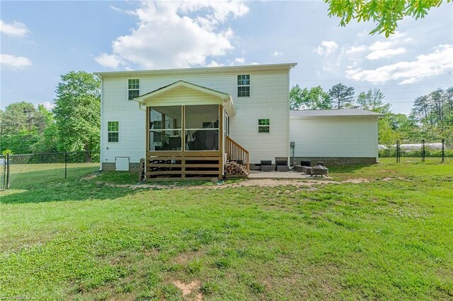 1765 Midway School Rd, Winston-Salem, NC 27107 - rear view of house featuring fence, a sunroom, a patio area, and a lawn