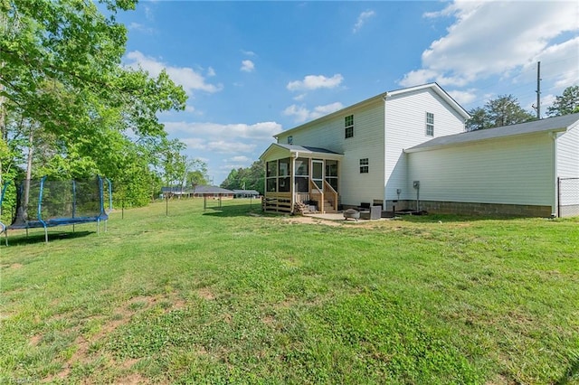 1765 Midway School Rd, Winston-Salem, NC 27107 - back of property with a yard, a trampoline, a sunroom, and fence