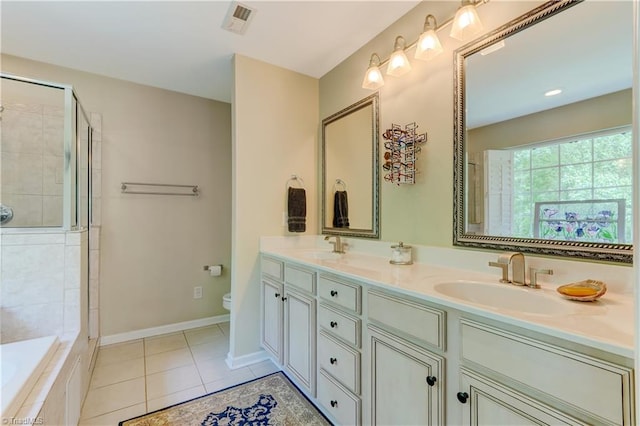 full bathroom with tile patterned flooring, double vanity, toilet, a sink, and a tile shower