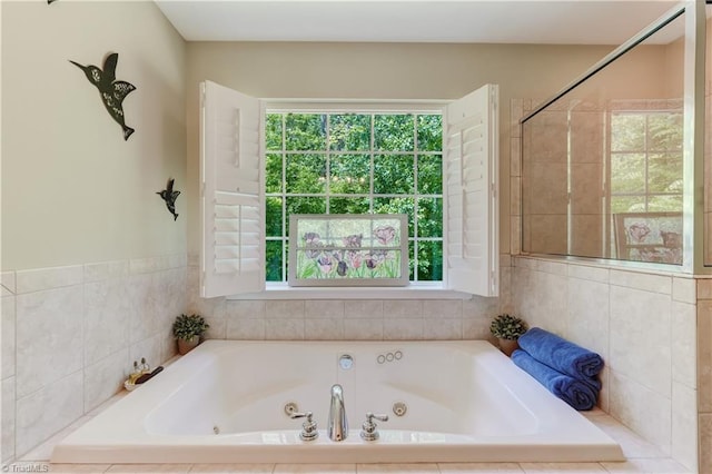 full bathroom with a jetted tub