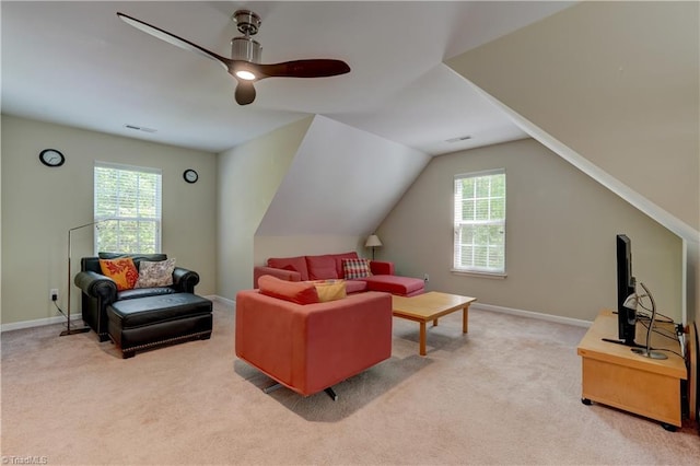 living area featuring light colored carpet, a ceiling fan, visible vents, and lofted ceiling