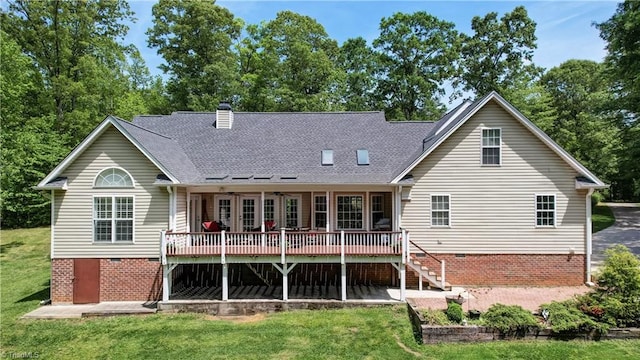 back of property featuring a lawn, crawl space, a wooden deck, and stairway