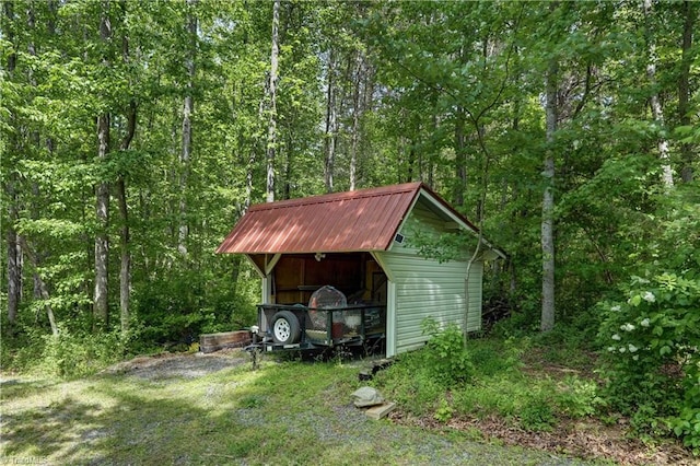 view of shed with a wooded view