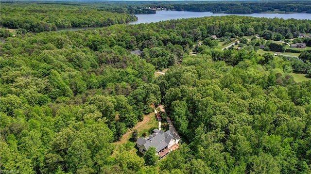 aerial view featuring a water view and a forest view