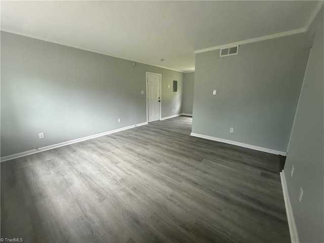 unfurnished room with crown molding, baseboards, visible vents, and dark wood-type flooring