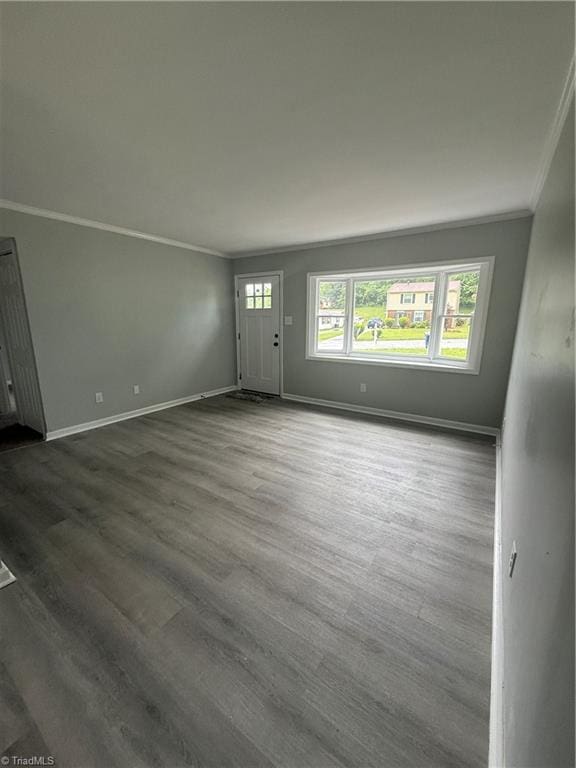 foyer featuring crown molding, baseboards, and dark wood-style floors