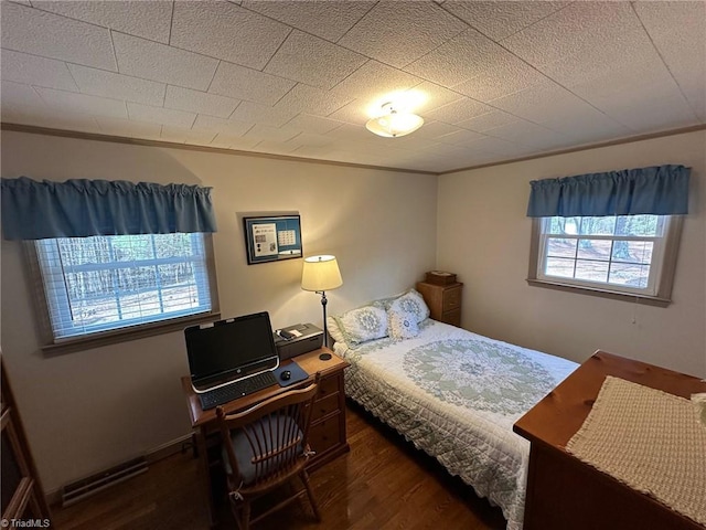 bedroom featuring crown molding and wood finished floors