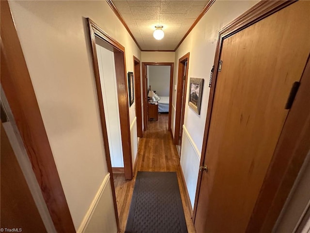 hallway featuring crown molding and light wood finished floors