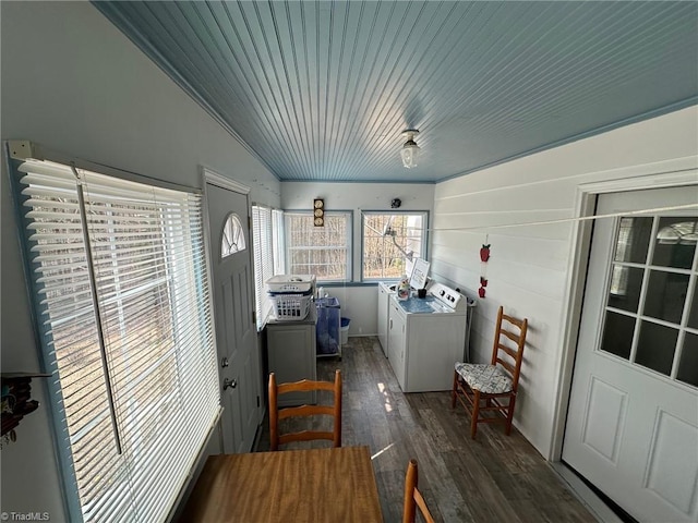 dining area featuring washing machine and dryer and dark wood-type flooring