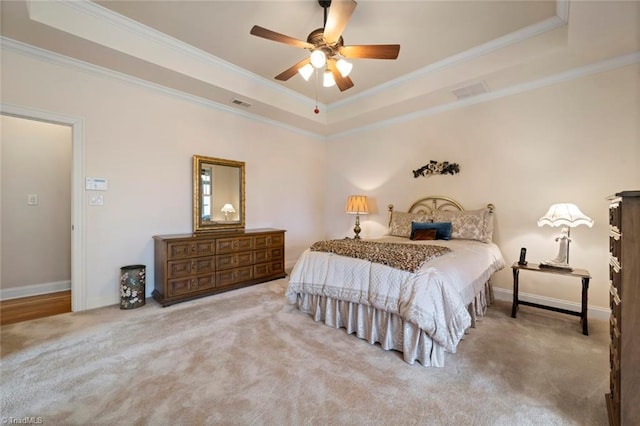 bedroom with visible vents, ornamental molding, baseboards, carpet, and a raised ceiling