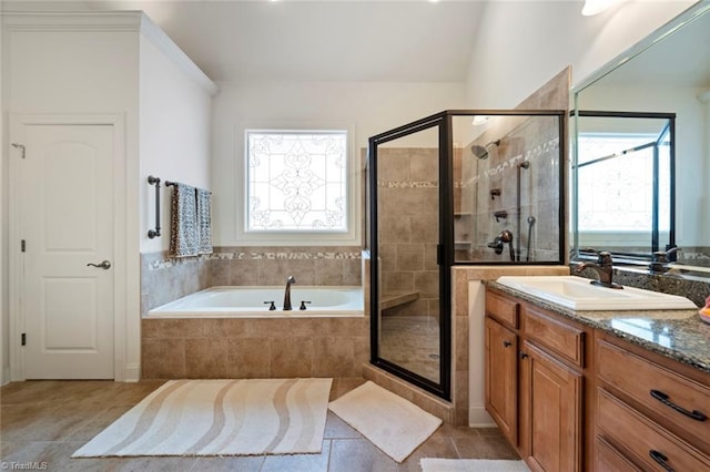 bathroom with a garden tub, a stall shower, and a wealth of natural light