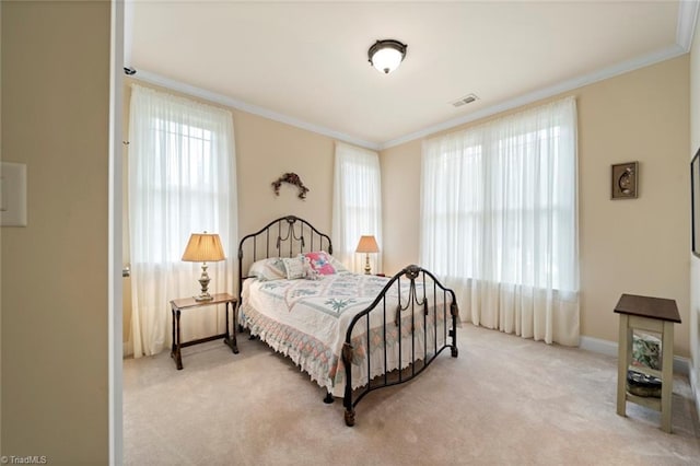 bedroom with baseboards, light colored carpet, visible vents, and ornamental molding