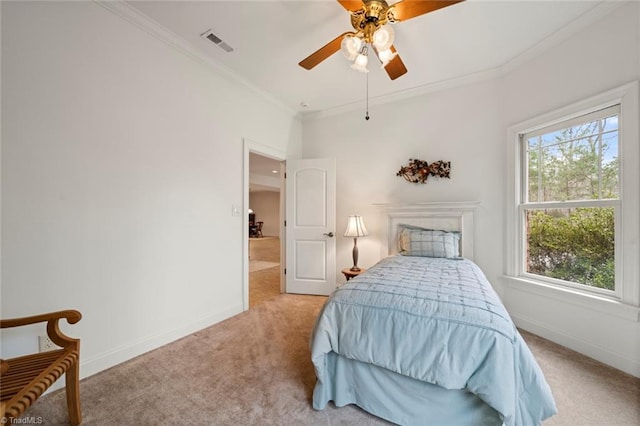 carpeted bedroom with visible vents, baseboards, a ceiling fan, and crown molding