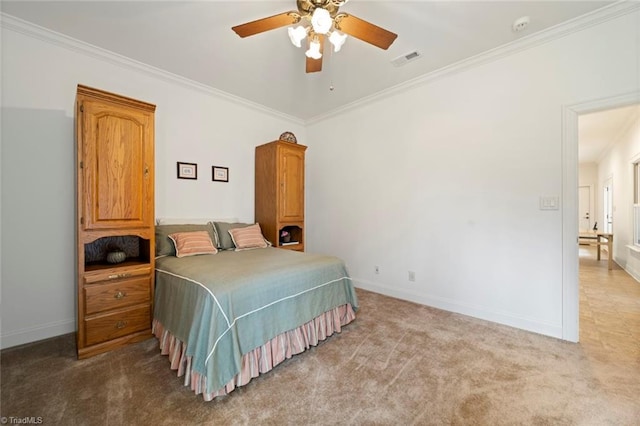 carpeted bedroom with visible vents, ceiling fan, baseboards, and ornamental molding