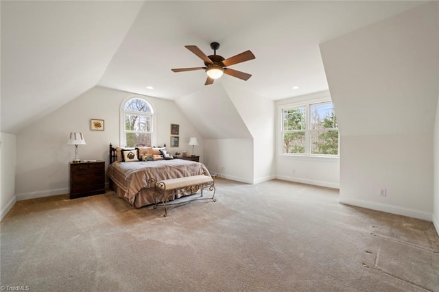 carpeted bedroom with lofted ceiling, baseboards, and ceiling fan