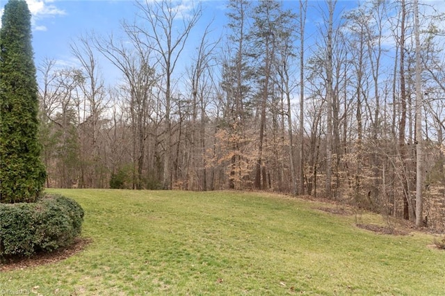 view of yard with a view of trees