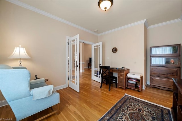 office area featuring light wood finished floors, french doors, baseboards, and ornamental molding