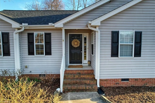 entrance to property featuring roof with shingles and crawl space