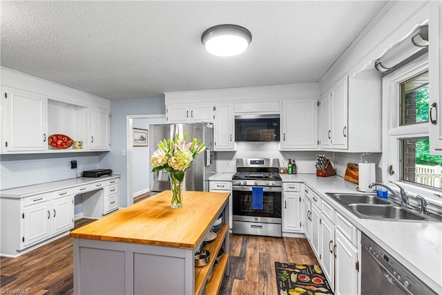 2215 Hickswood Rd, High Point, NC 27265 - kitchen featuring stainless steel appliances, wooden counters, white cabinets, a kitchen island, and dark wood-style floors