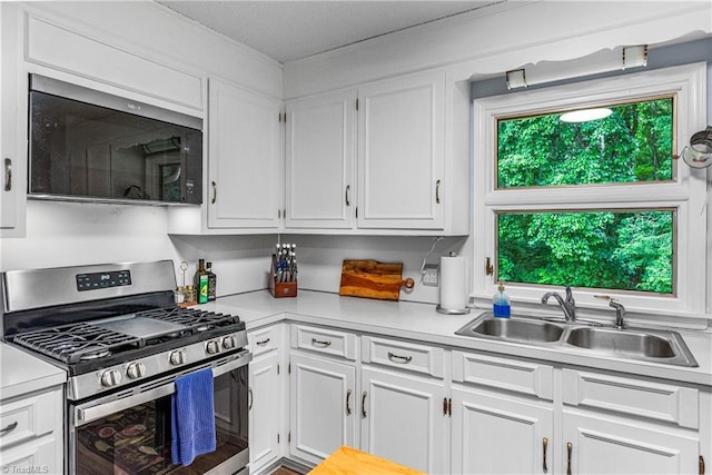 2215 Hickswood Rd, High Point, NC 27265 - kitchen with gas range, white cabinets, and light countertops