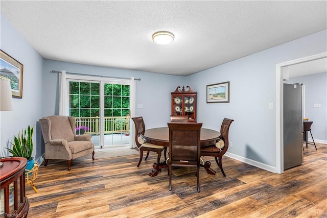 2215 Hickswood Rd, High Point, NC 27265 - dining room featuring wood finished floors and a textured ceiling
