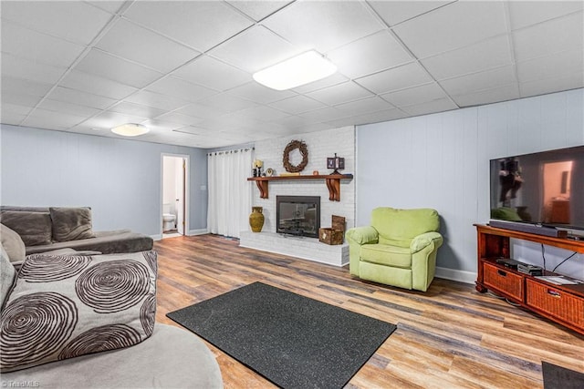 2215 Hickswood Rd, High Point, NC 27265 - living area featuring a paneled ceiling, wood finished floors, and a fireplace
