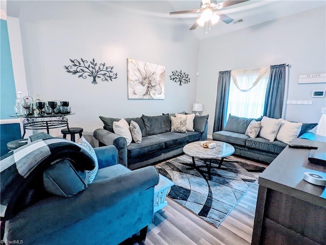 living room featuring light hardwood / wood-style floors and ceiling fan