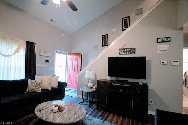 living room featuring dark hardwood / wood-style floors, high vaulted ceiling, and ceiling fan