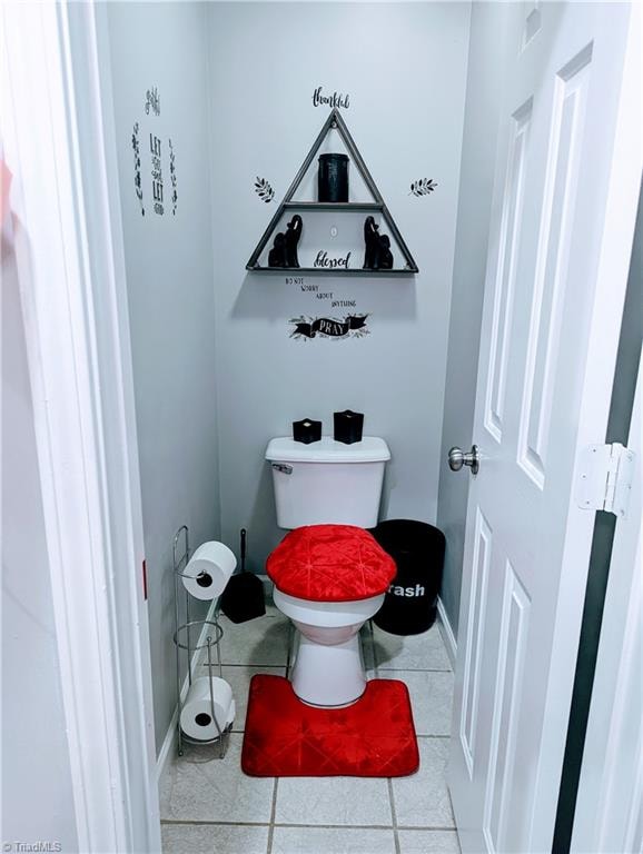 bathroom featuring toilet and tile patterned flooring