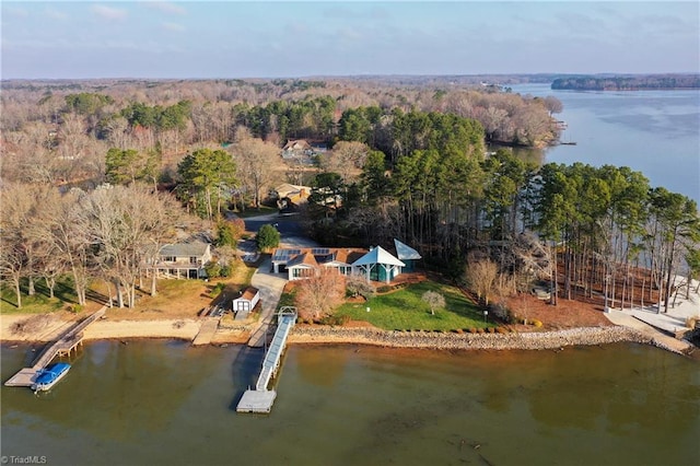 aerial view with a wooded view and a water view