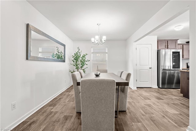 574 Freeport Ct, Winston-Salem, NC 27127 - dining room with a chandelier, wood finished floors, and baseboards