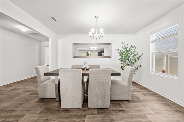 574 Freeport Ct, Winston-Salem, NC 27127 - dining room with a chandelier, wood finished floors, and baseboards