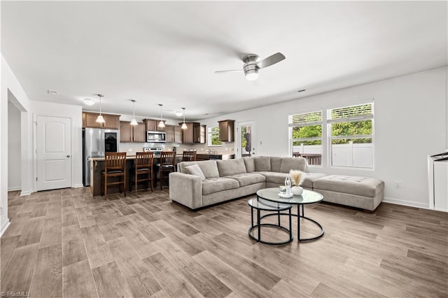 574 Freeport Ct, Winston-Salem, NC 27127 - living area featuring a ceiling fan, light wood-style flooring, and baseboards