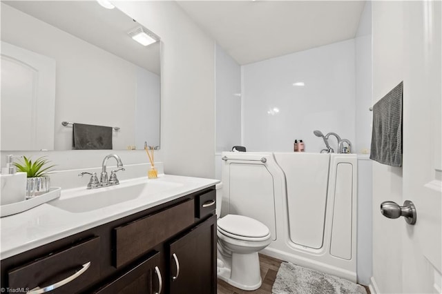 574 Freeport Ct, Winston-Salem, NC 27127 - full bath featuring vanity, wood finished floors, toilet, and a bathtub