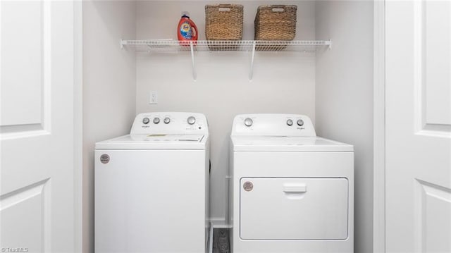 clothes washing area with separate washer and dryer