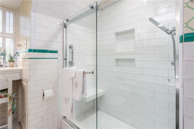 full bathroom featuring tile walls and a stall shower