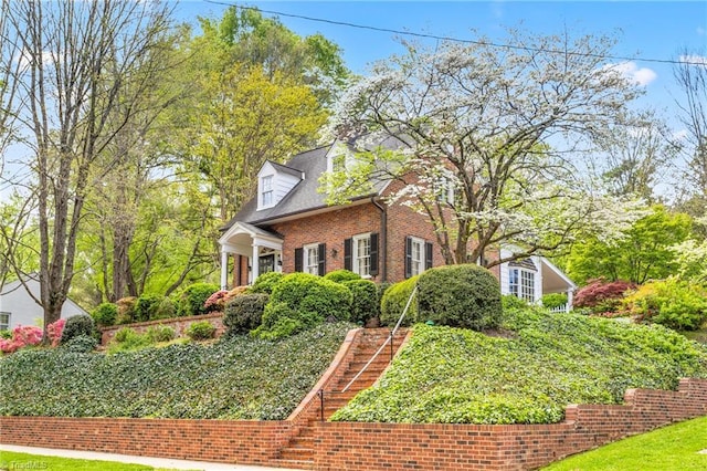 view of side of home featuring brick siding