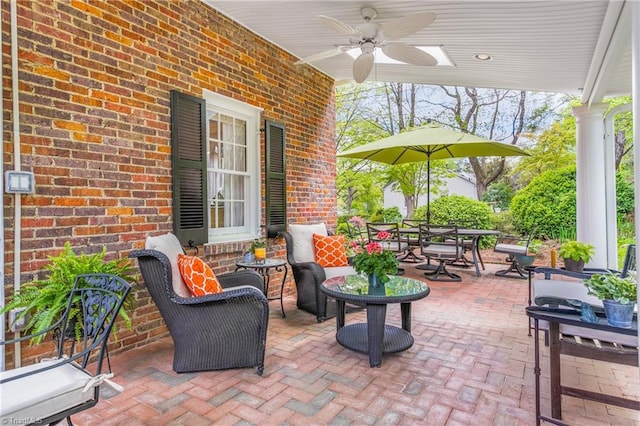 view of patio with outdoor dining area and ceiling fan