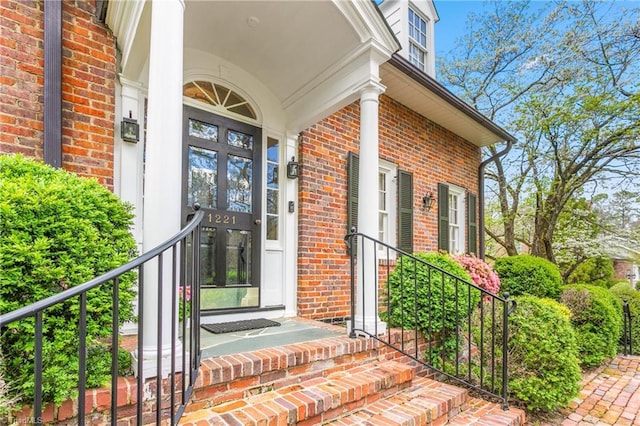 property entrance featuring brick siding