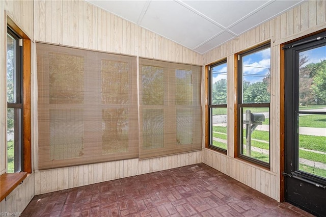 3753 Konnoak Dr SW, Winston-Salem, NC 27127 - unfurnished sunroom featuring brick patterned flooring, wood walls, and vaulted ceiling