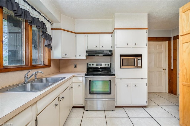 3753 Konnoak Dr SW, Winston-Salem, NC 27127 - kitchen with stainless steel appliances, under cabinet range hood, light countertops, light tile patterned floors, and white cabinets