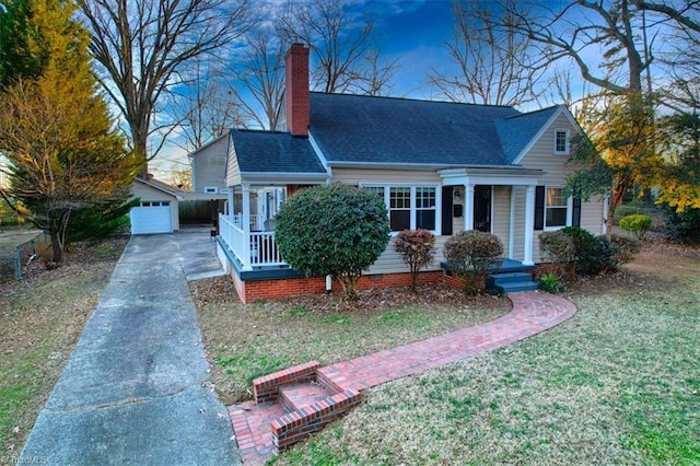 view of front of home featuring an outbuilding, a garage, and a front yard