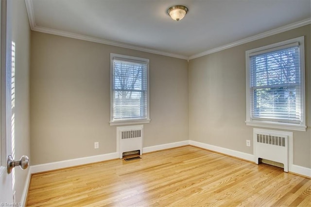 unfurnished room featuring light hardwood / wood-style flooring, radiator, and ornamental molding