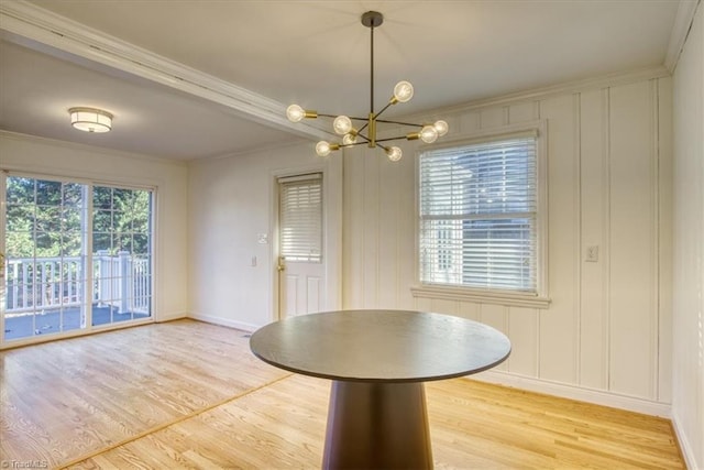 unfurnished dining area featuring ornamental molding and a chandelier