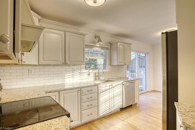 kitchen with light stone countertops, backsplash, and stainless steel appliances